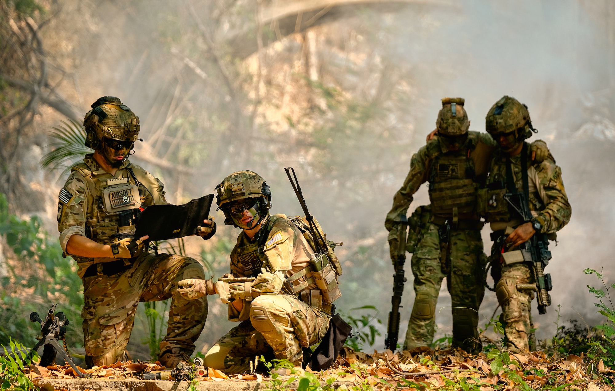 The army stop and discuss together before go to next place during fighting in the forest.