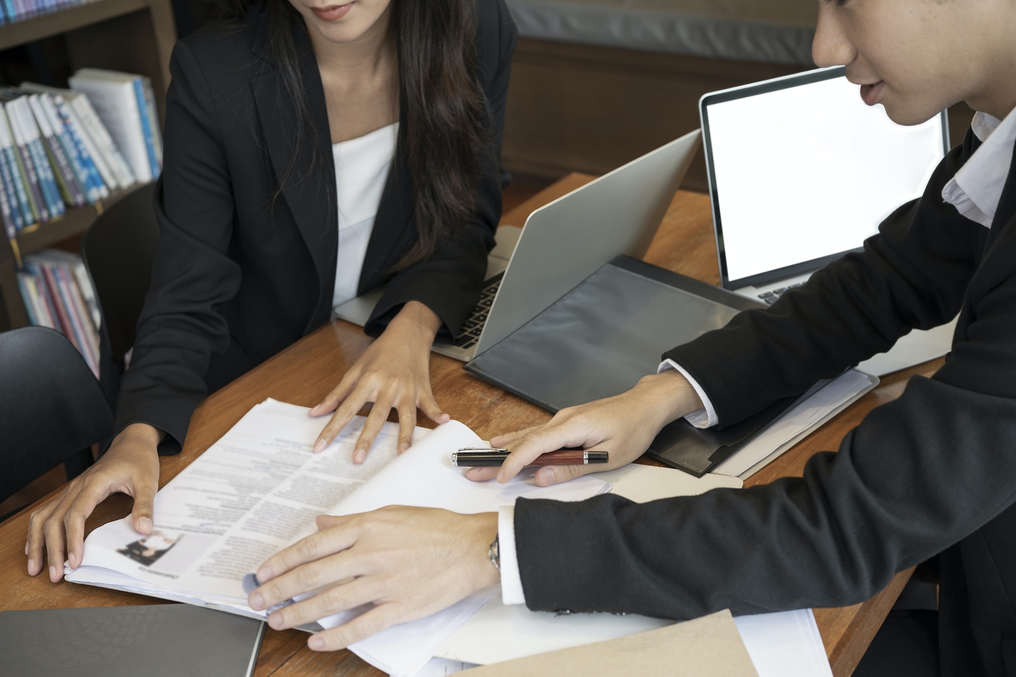 Group of human resources managers reading cv resume before interview candidature on free vacancy.